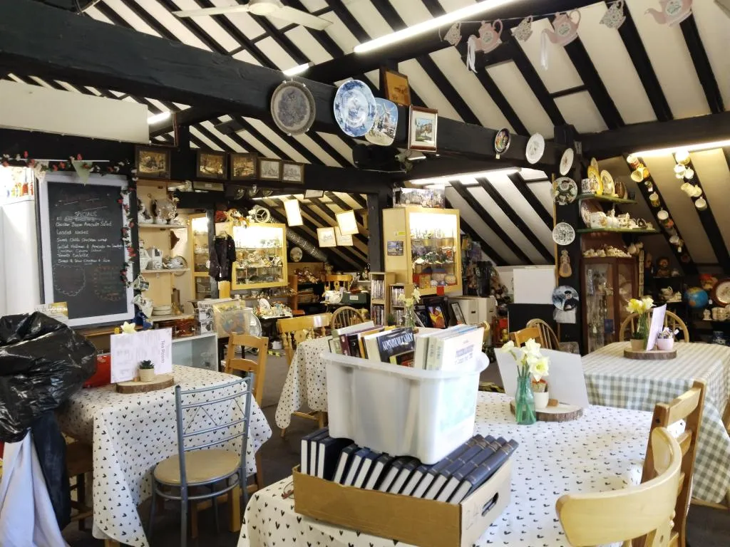 Quaint coffee shop on the top floor, surrounded by antiques and vintage décor.