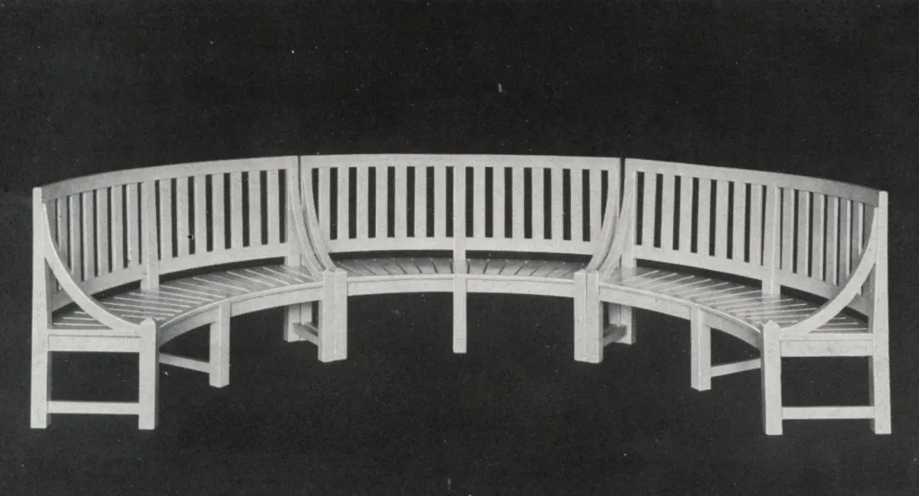 Vintage illustration of a curved wooden garden bench with a slatted backrest and seat, featuring a graceful semicircular design intended for formal gardens and outdoor landscapes.