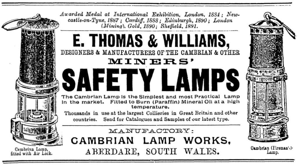 1900 advertisement for E. Thomas & Williams Cambrian safety lamps, showing two lamp types (Air Lock and Fireman’s), promotional claims of international awards, and manufacture at Cambrian Lamp Works, Aberdare, South Wales.