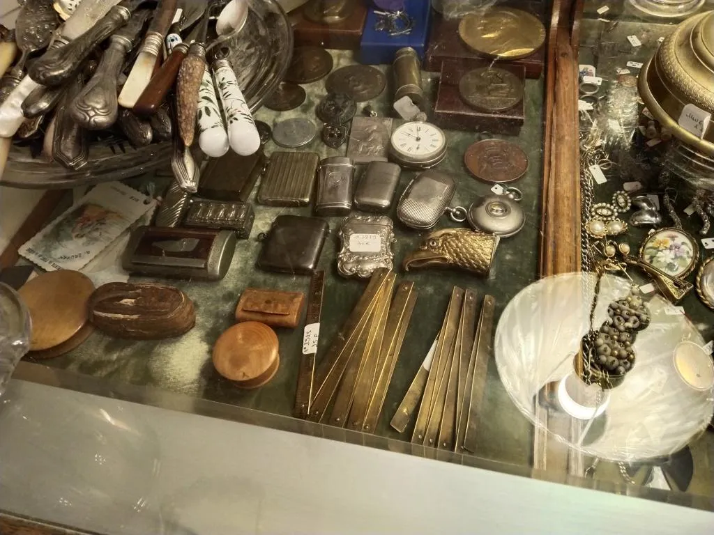 A treasure trove of smalls: vintage silverware, vesta cases, pocket watches, and charming curiosities on display at L’Estive Antiques.