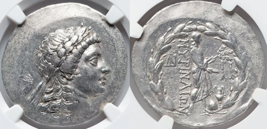 Ancient Greek silver tetradrachm coin from Myrina in Aeolis, dated circa 150 BC, showing a laureate head of Apollo right on the obverse and Apollo Gryneios standing within a laurel wreath on the reverse, in an NGC holder.