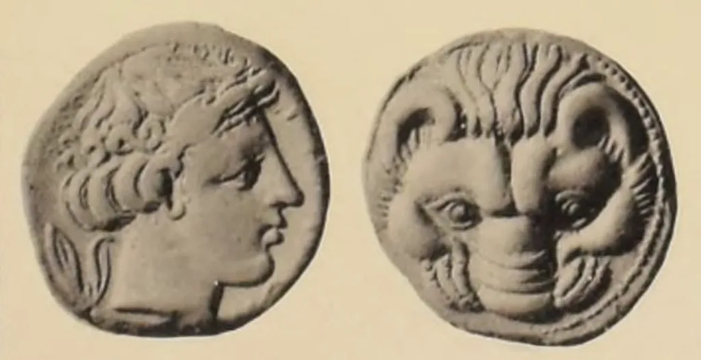 Ancient Greek silver tetradrachm from Rhegion in Bruttium, shown obverse and reverse on a light background: Apollo wears a laurel wreath and faces right, while the reverse presents a frontal lion’s head in bold archaic style.