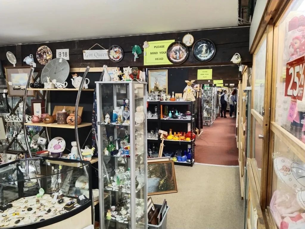 Dealer boxes filled with glassware, ceramics, and collectibles—showcasing Riverside’s dense layout.