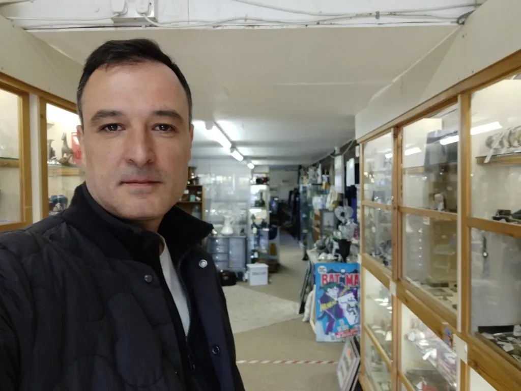 Inside the main floor of Riverside Antiques Centre, featuring well-stocked glass cabinets filled with smalls, collectibles, and vintage curios.