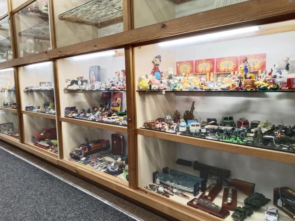 Glass cabinets filled with vintage toys, model cars, action figures, and collectibles—part of Riverside’s extensive toy section.