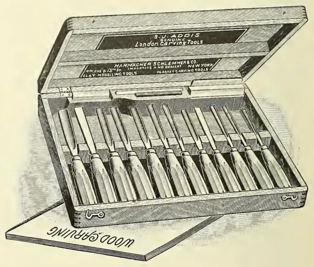Engraved illustration of an open wooden case containing a complete set of ten handled wood carving tools, mostly chisels and gouges. The case lid is labeled S. J. ADDIS GENUINE LONDON CARVING TOOLS and HAMMACHER SCHLEMMER & CO. NEW YORK. The words WOOD CARVING are visible in reverse on a block beneath the case.
