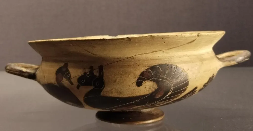 Antike spätkorinthische Kylix mit rundem Gefäßkörper und zwei Henkeln, verziert mit Wasservögeln im Profil. Datiert auf 570–550 v. Chr.