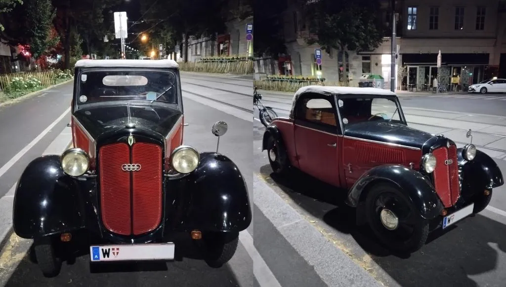 Vintage DKW F8 Cabriolet in red and black, parked on a city street at night with tram tracks in the background.