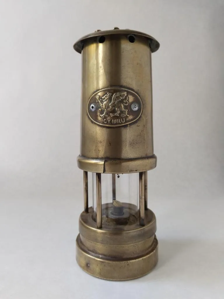 Antique Welsh Miner's Lamp (CYMRU), an original brass lantern measuring 21cm. A treasured find from The Gallery Antiques in Sawbridgeworth.