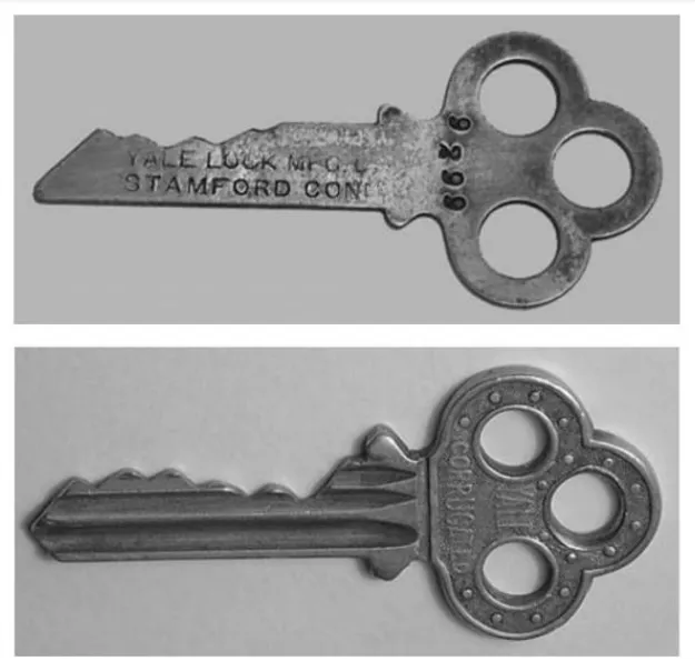 Comparison of two Yale key designs— a flat key and a corrugated key. The flat key represents an earlier design, while the corrugated key introduced additional security features for improved lock protection.